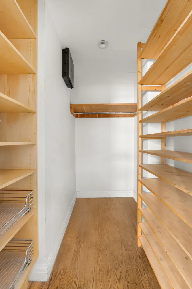 a view of walk in closet with empty racks