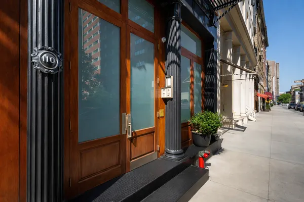 a view of a street with potted plants