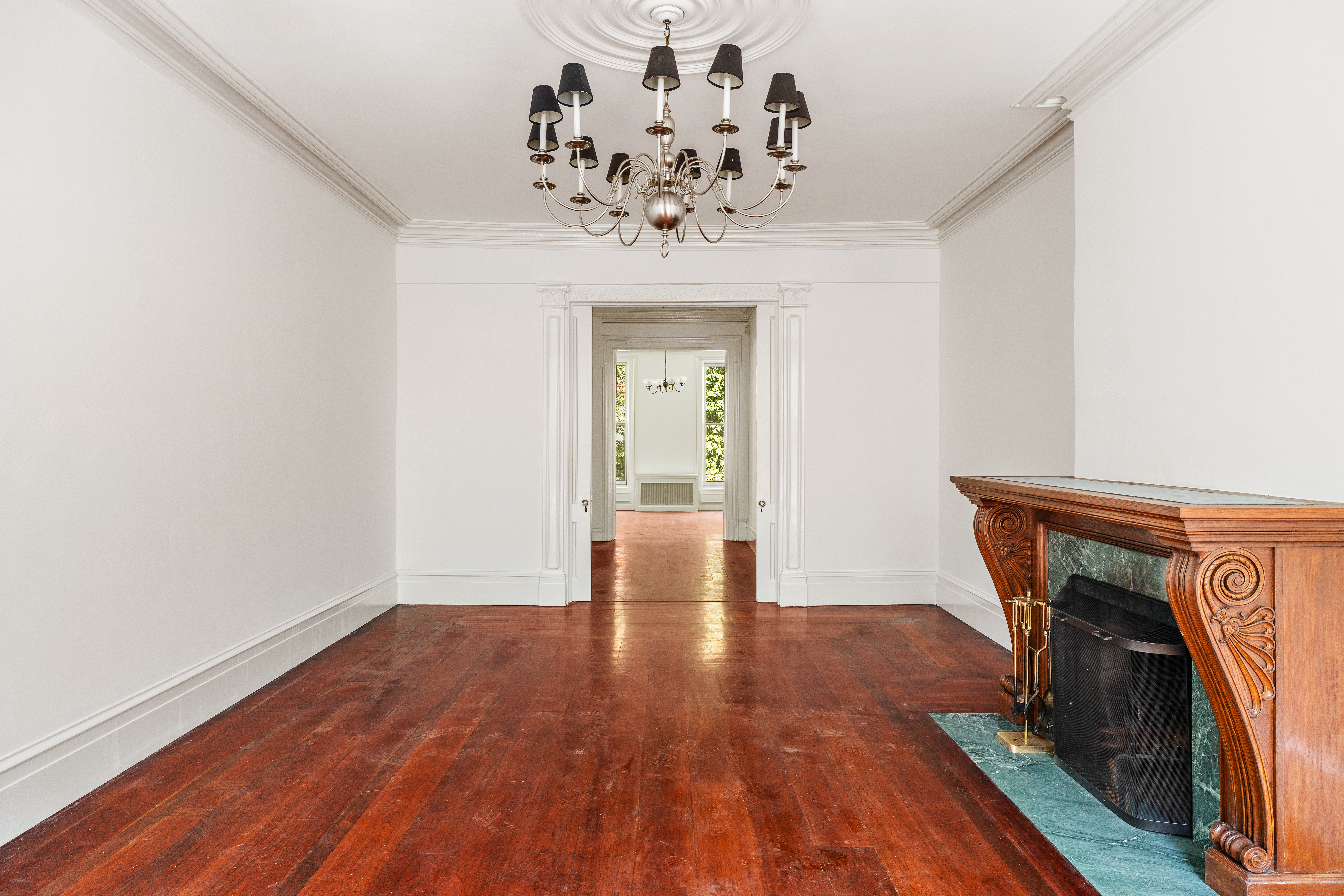 225 West 22nd Street Manhattan, NY 10011 - Photo 7 of 12 a view of a livingroom with wooden floor and a chandelier