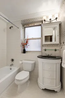 a bathroom with a stove a sink and a bathtub