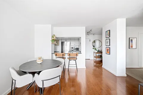 a view of a dining room with furniture and wooden floor