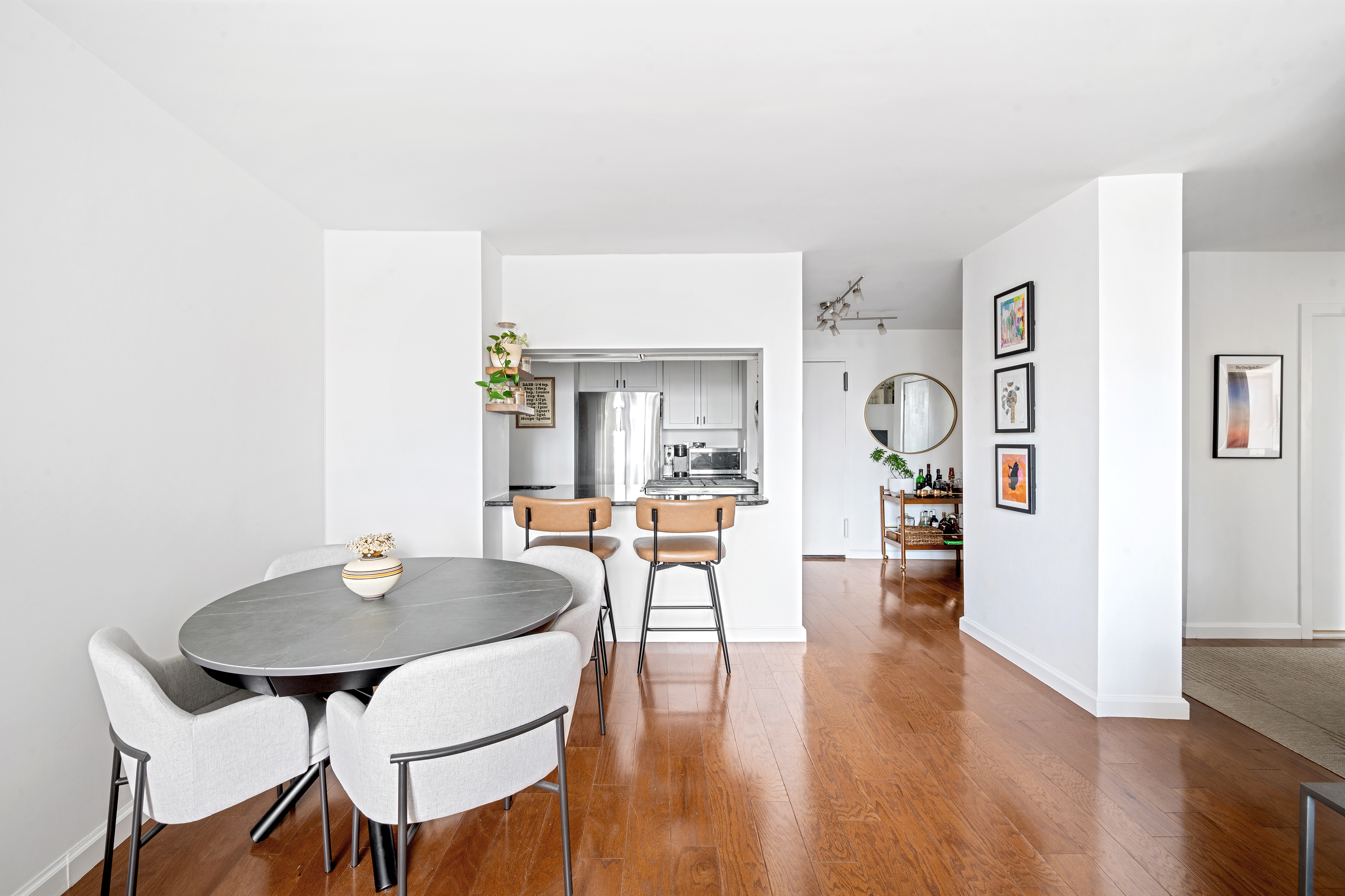 245 East 54th Street, Unit 26JK Manhattan, NY 10022 - Photo 3 of 12 a view of a dining room with furniture and wooden floor