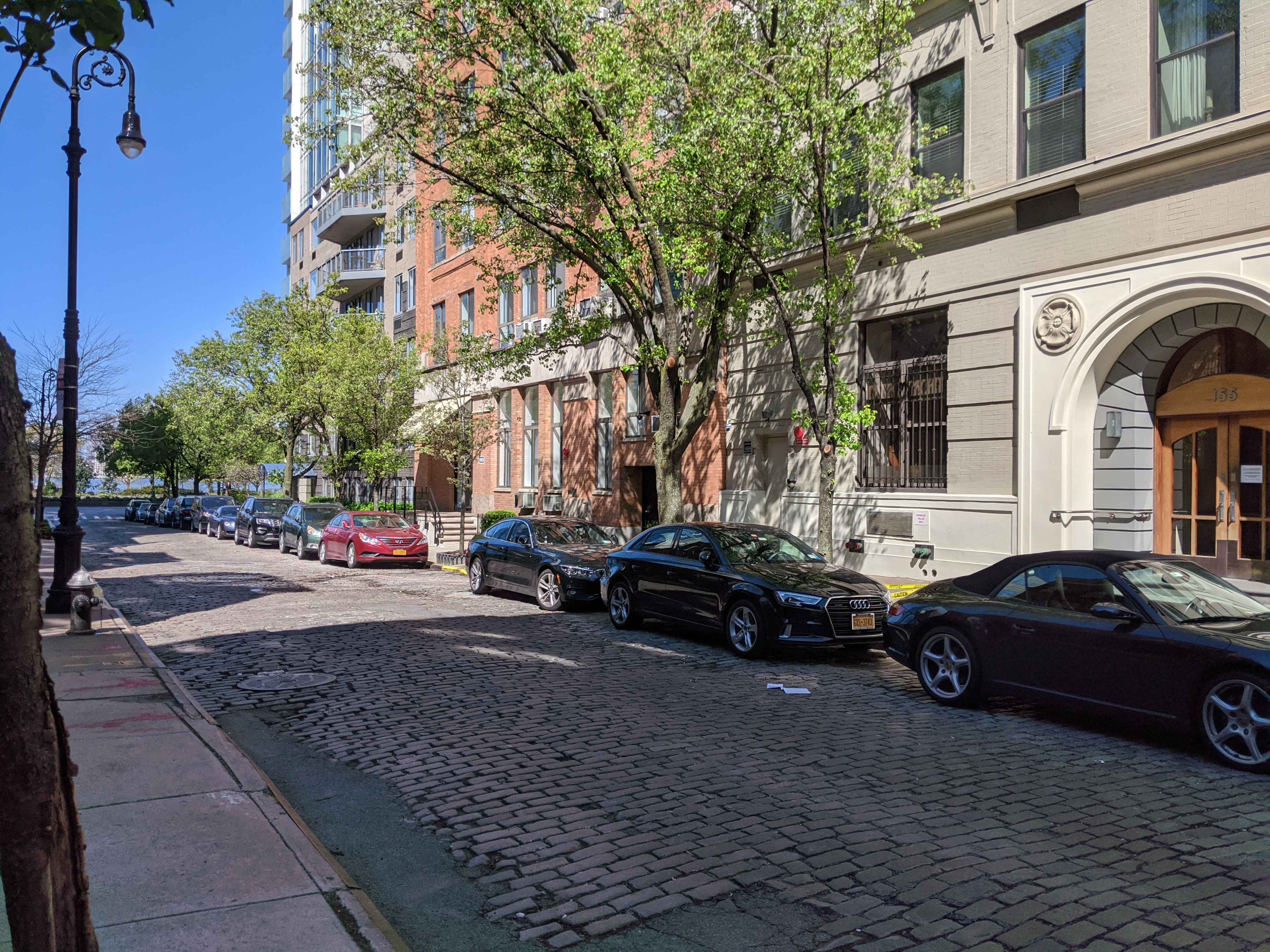 167 Perry Street, Unit 5F Manhattan, NY 10014 - Photo 6 of 12 a car parked in front of a brick house