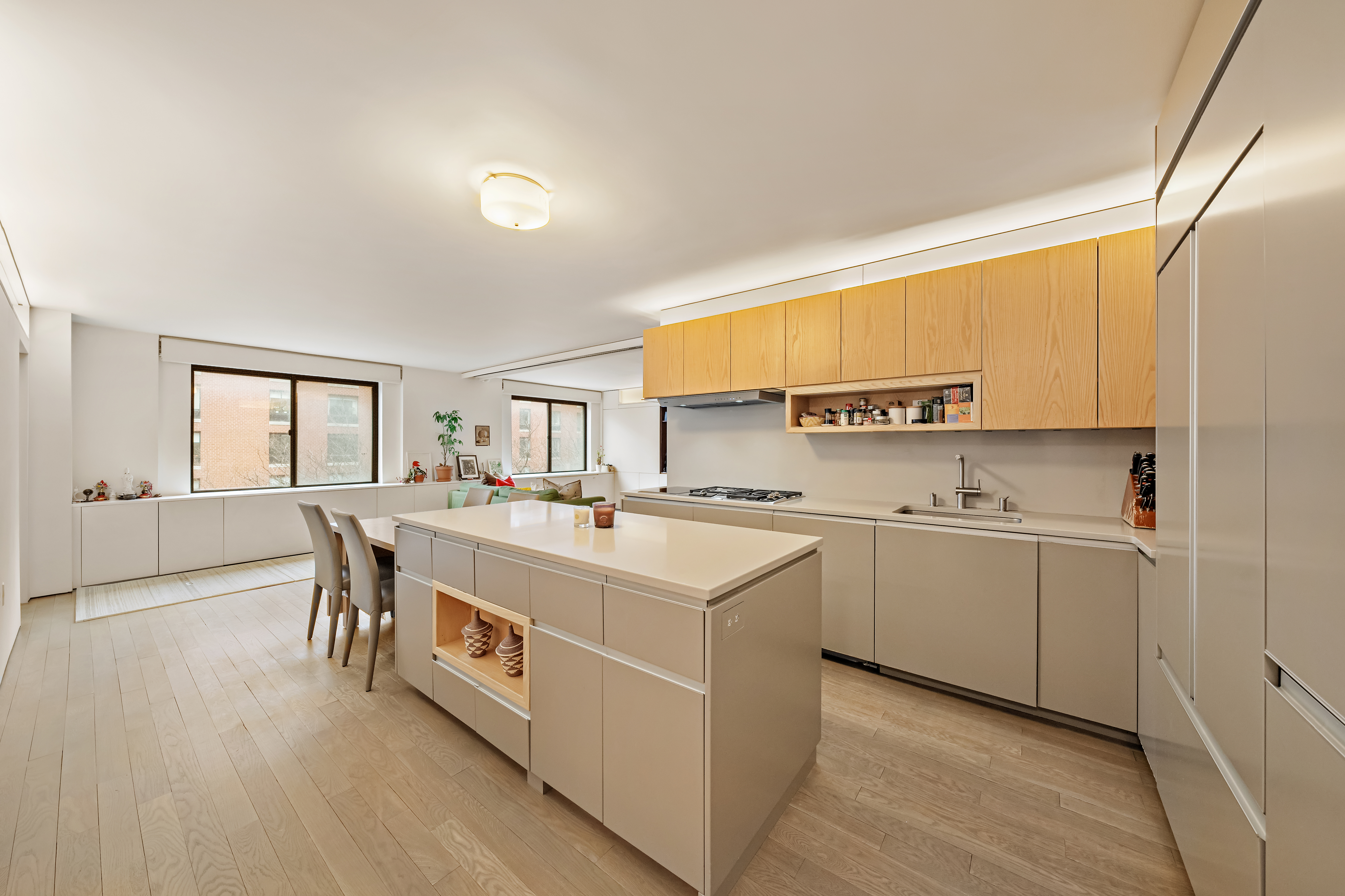 280 Rector Place, Unit 5IJ Manhattan, NY 10280 - Photo 2 of 10 a large white kitchen with a stove a sink dishwasher and a refrigerator with wooden floor