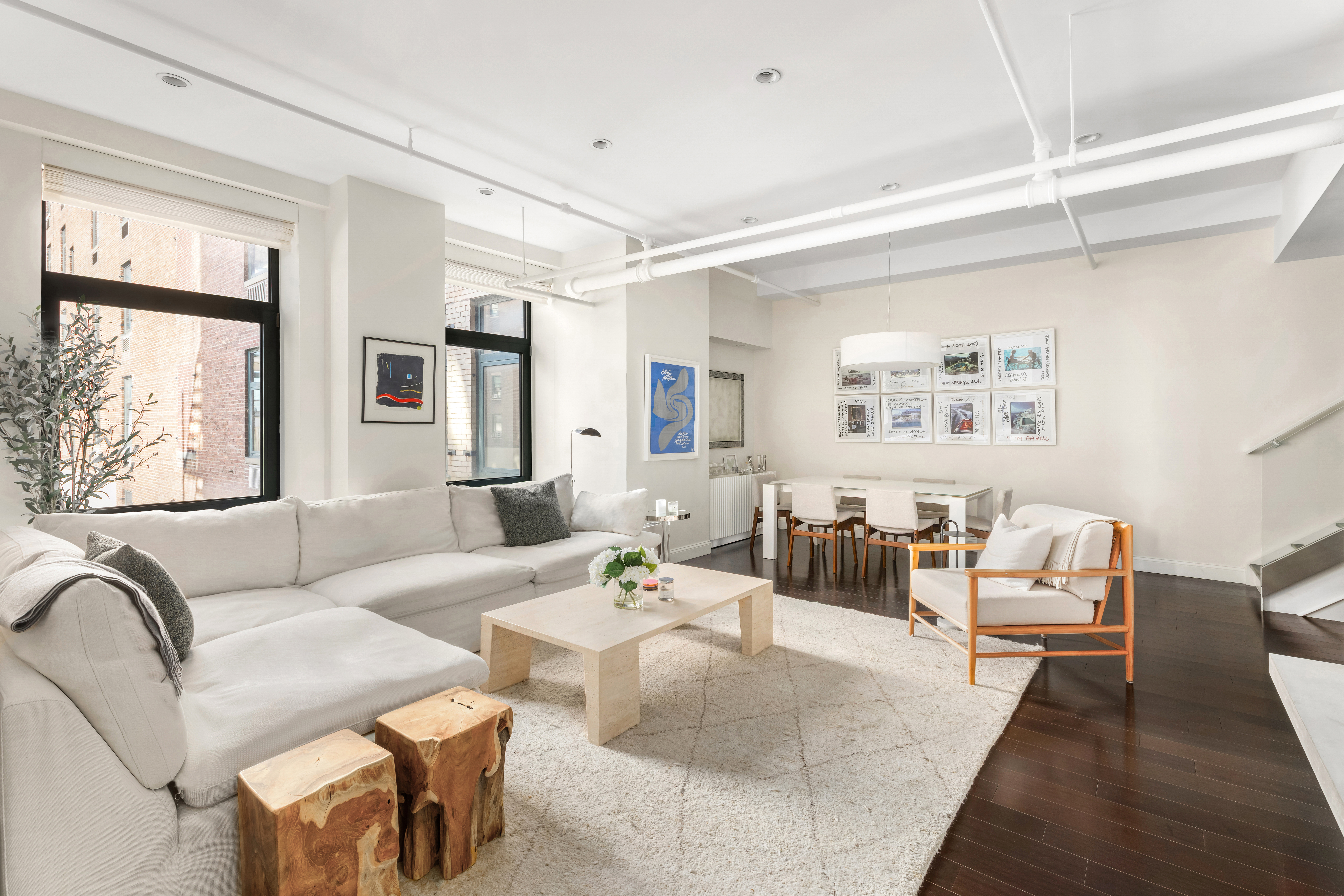 14 East 4th Street, Unit 803 Manhattan, NY 10012 - Photo 2 of 11 a living room with furniture and a large window