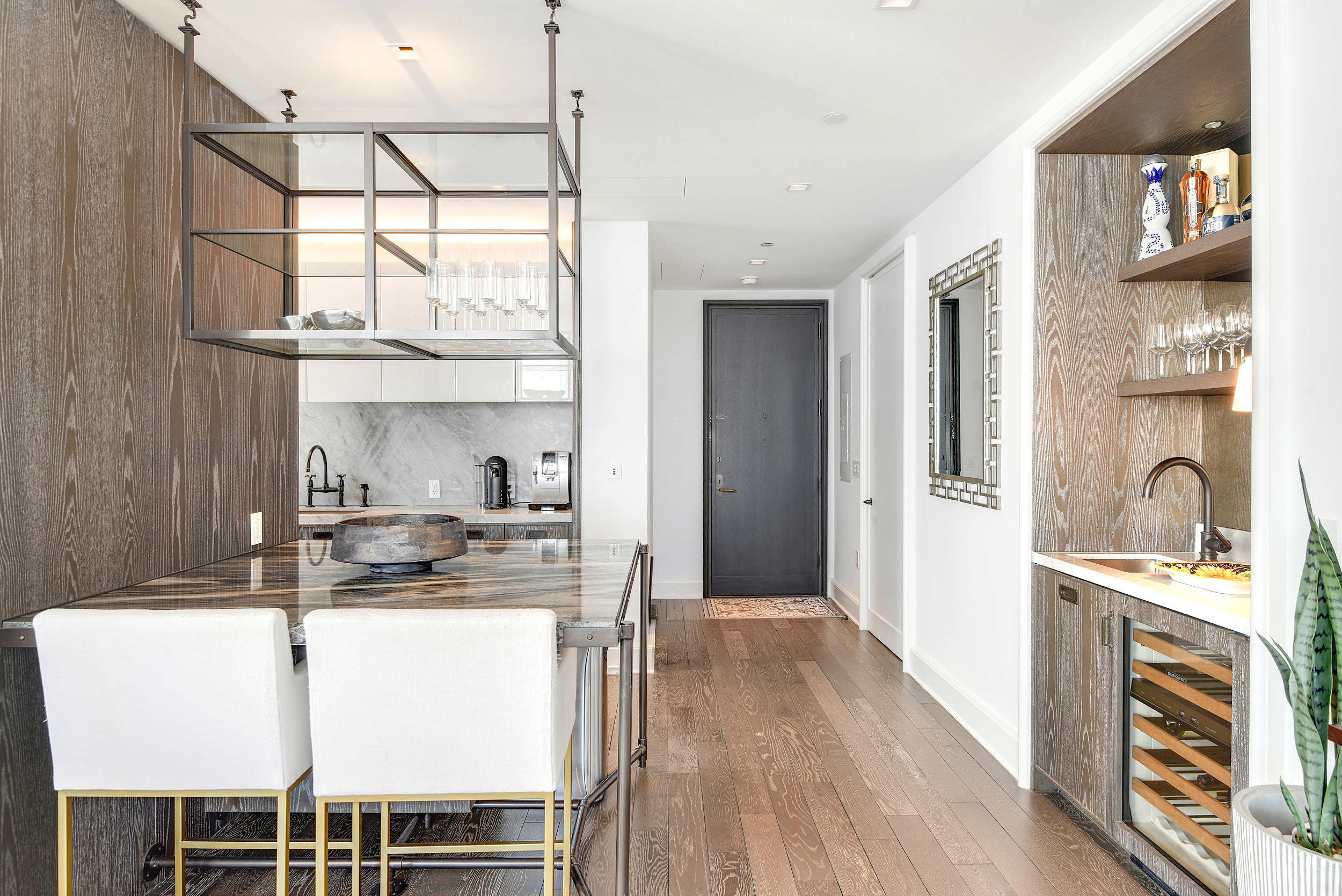 45 East 22nd Street, Unit 34A Manhattan, NY 10010 - Photo 3 of 24 a kitchen with stainless steel appliances granite countertop a stove a sink and a refrigerator with wooden floor