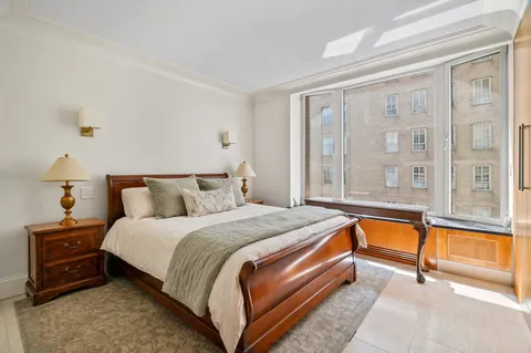 a spacious bedroom with a bed and a large window