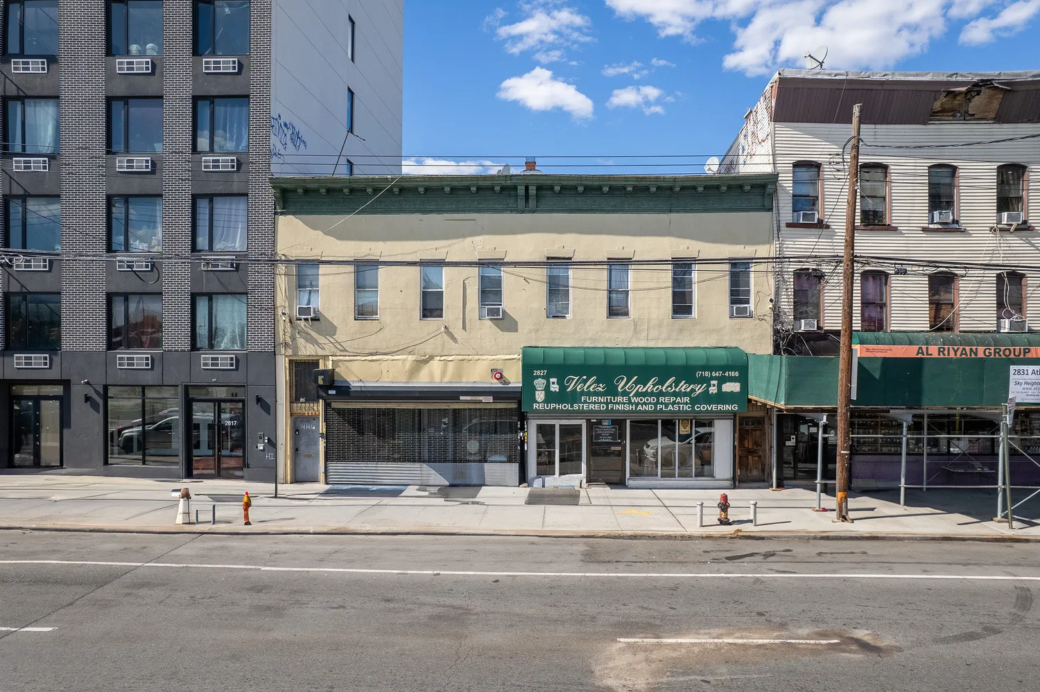 a front view of a building with a garden