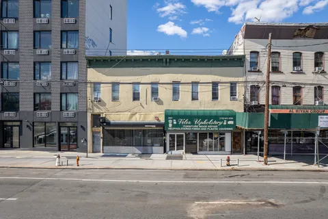 a front view of a building with a garden