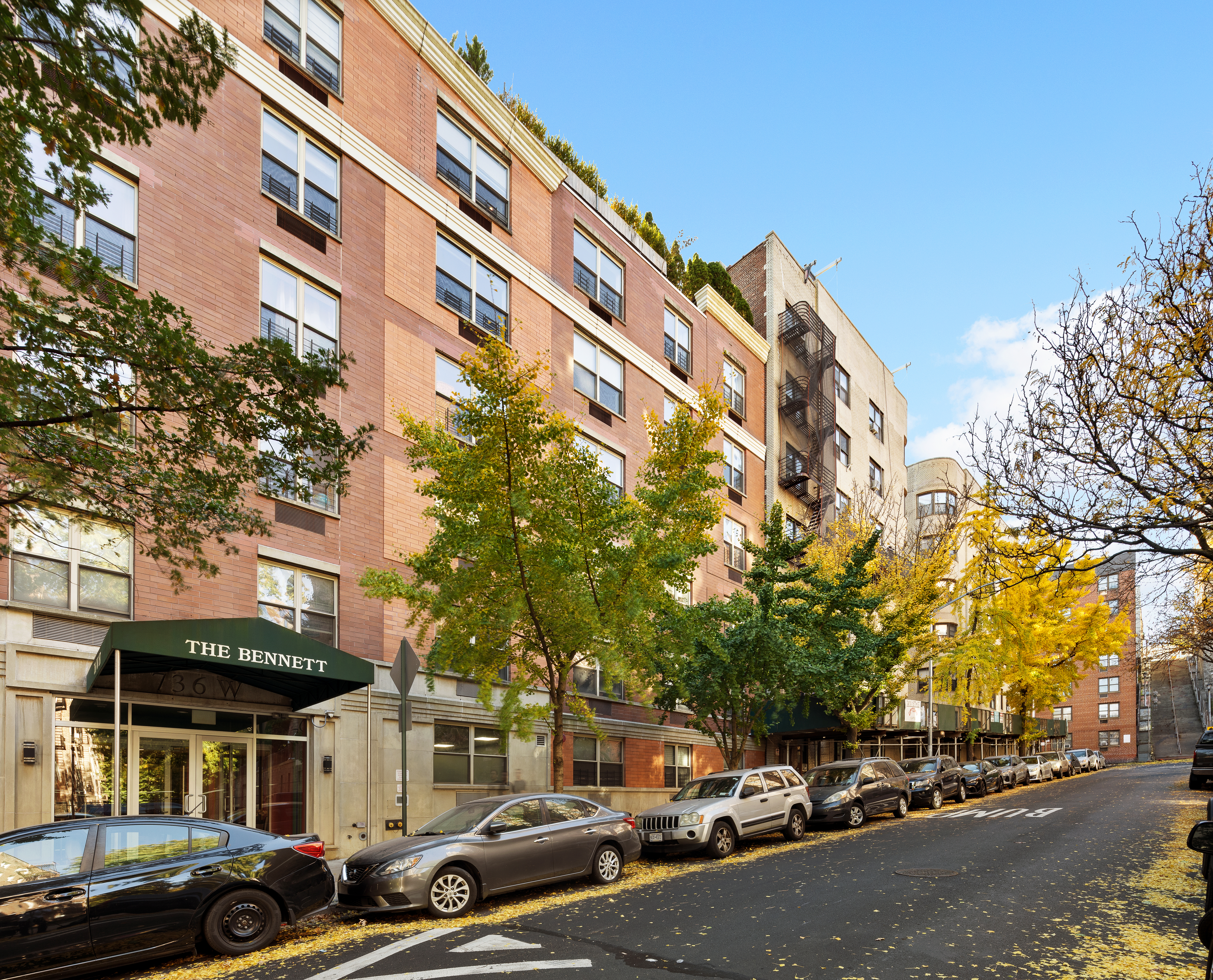 736 West 187th Street, Unit 303 Manhattan, NY 10033 - Photo 15 of 16 a city street lined with parked cars front of buildings