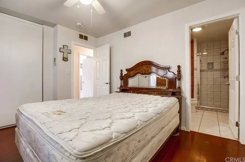 15604 Deblynn Avenue Gardena, CA 90248 - Photo 16 of 22 a bedroom with a bed and a mirror