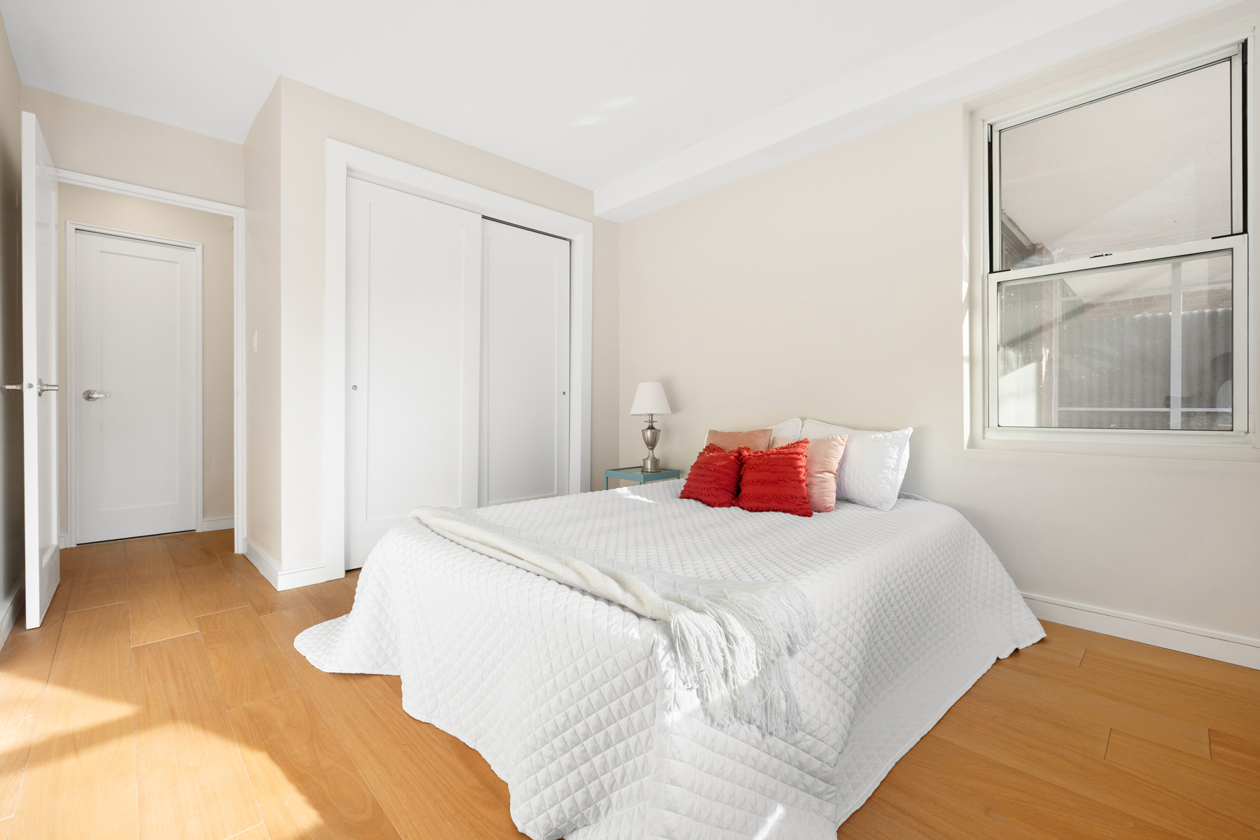 35-51 85th Street, Unit 5E Queens, NY 11372 - Photo 10 of 16 a bedroom with a bed and a window