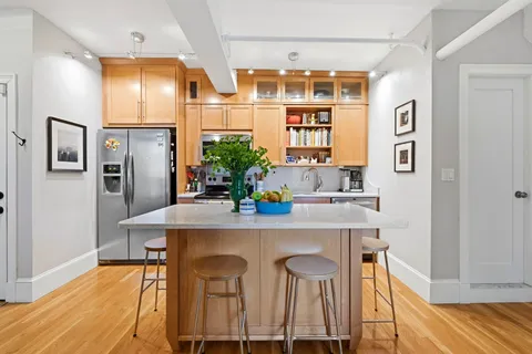 a dining room with a table chairs and refrigerator