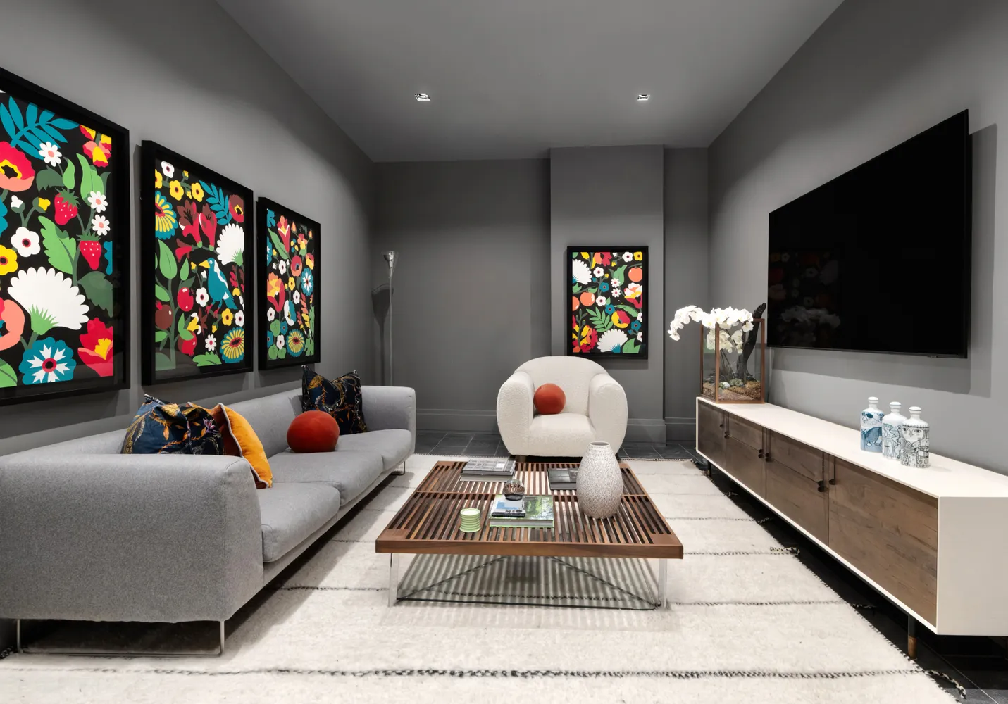 a living room with furniture a flat screen tv and a flat screen tv