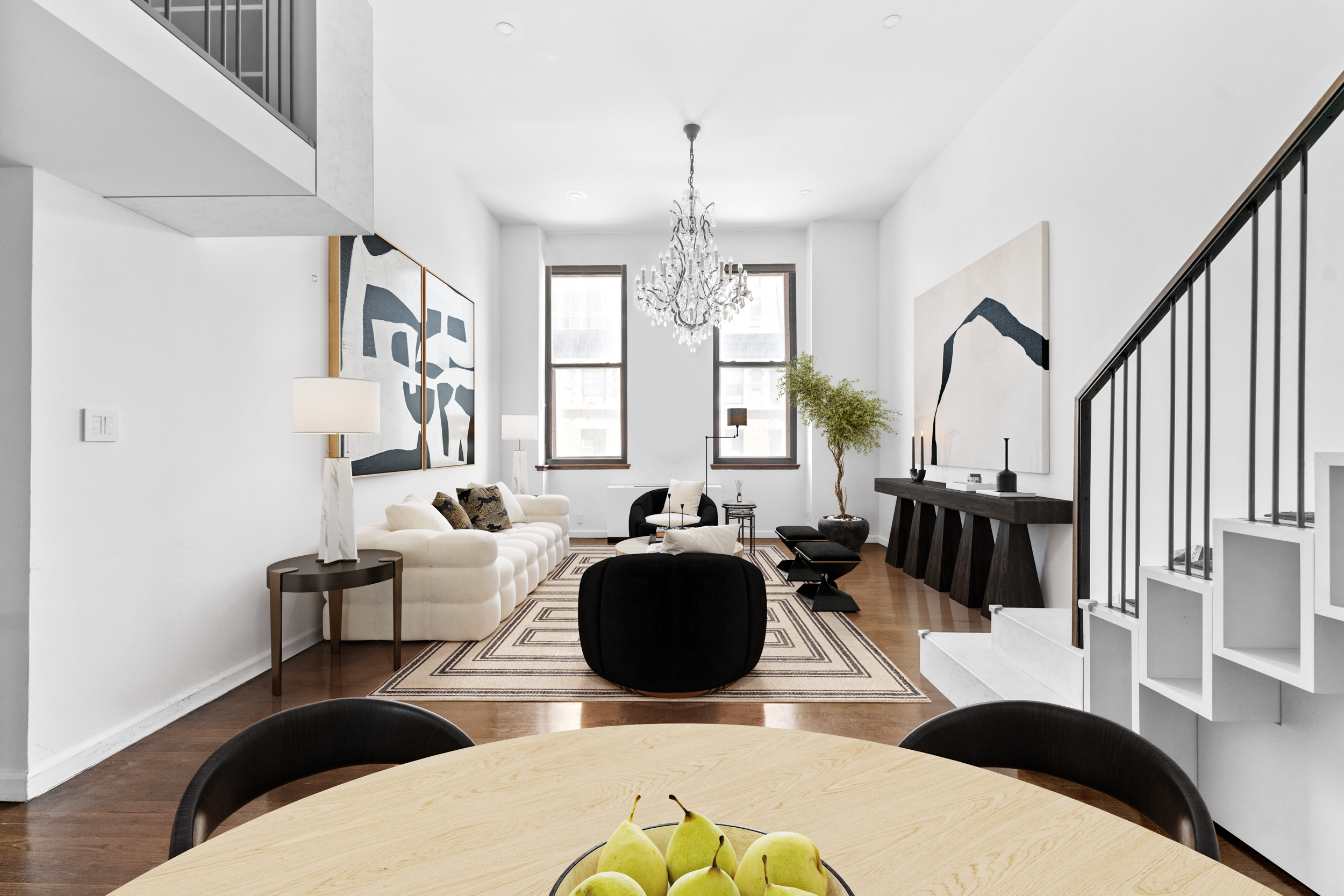 305 2nd Avenue, Unit 320 Manhattan, NY 10003 - Photo 3 of 16 a living room with furniture and a chandelier