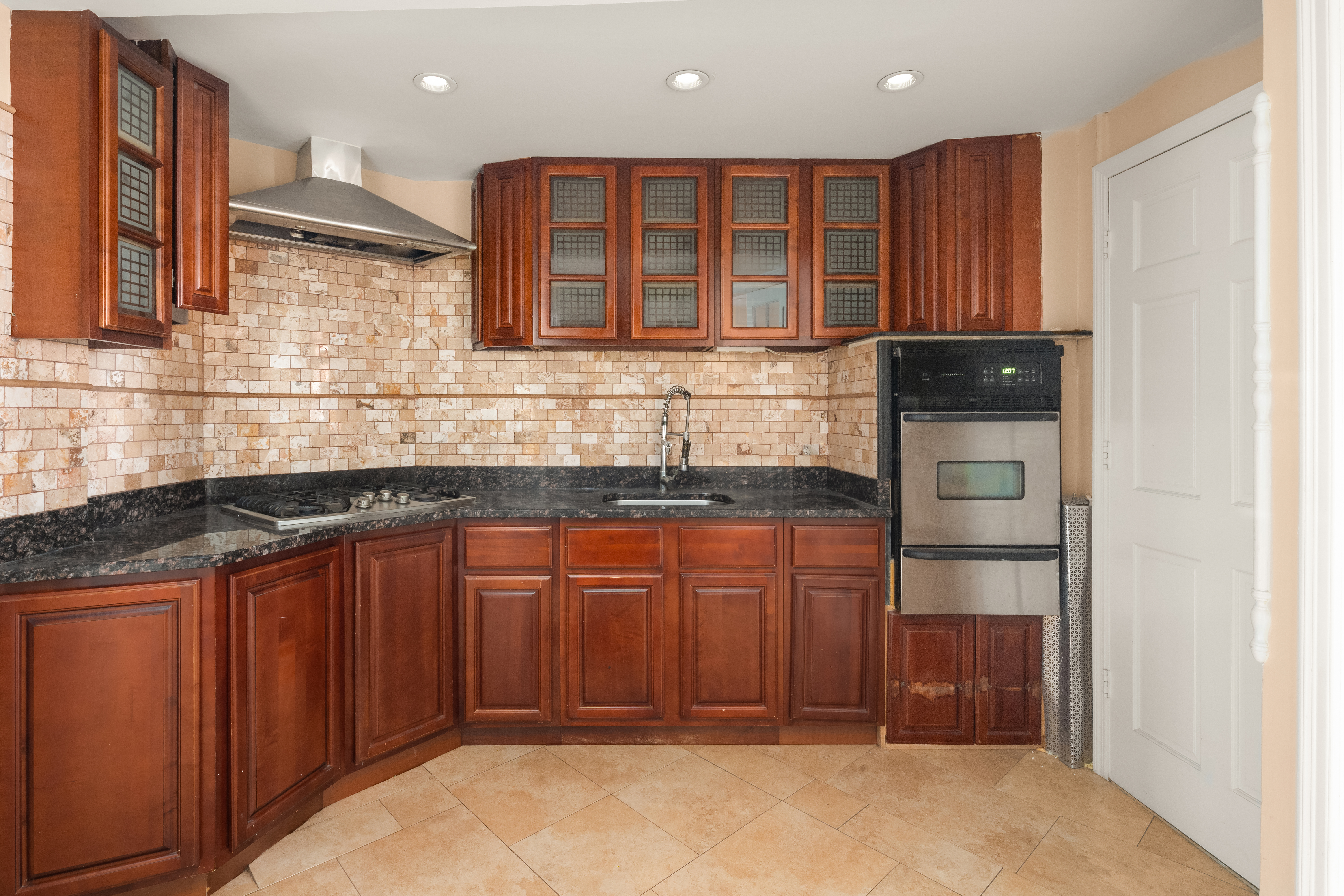 1135 Park Place Brooklyn, NY 11213 - Photo 15 of 18 a kitchen with stainless steel appliances granite countertop wooden cabinets and a sink