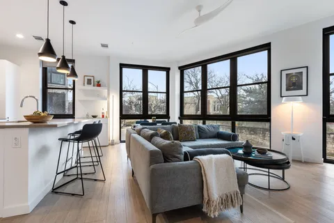 a living room with furniture and a wooden floor