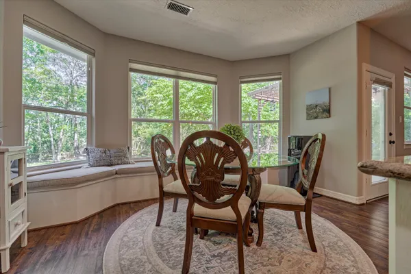a view of a dining room with furniture window and wooden floor