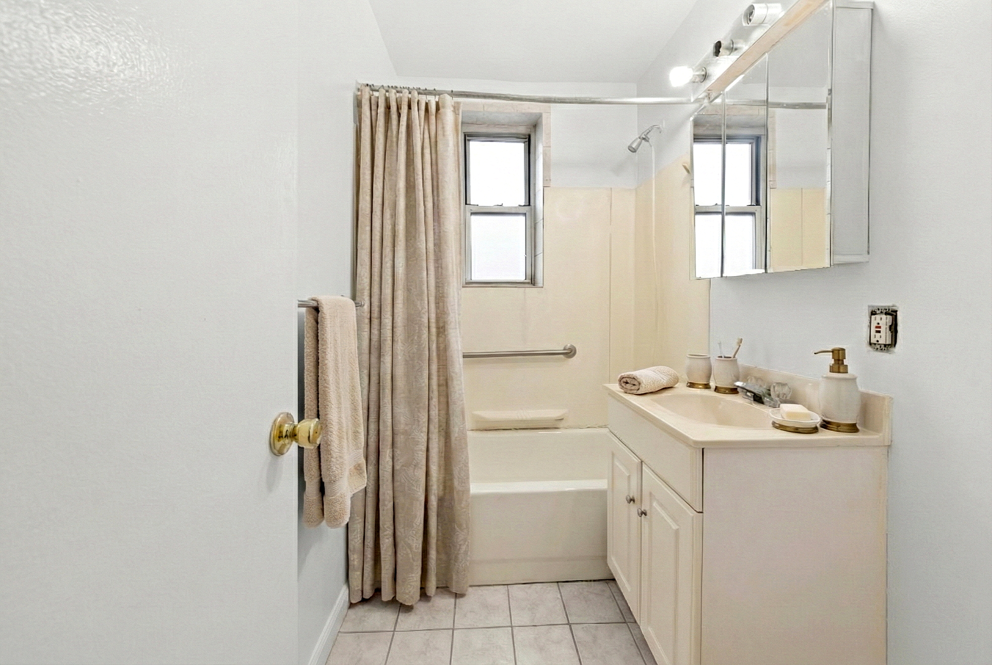 3210 Arlington Avenue, Unit 3D Bronx, NY 10463 - Photo 10 of 24 a bathroom with a sink a toilet and a tub