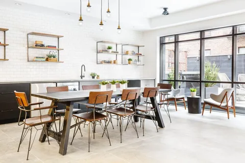 a dining area with furniture and a large window