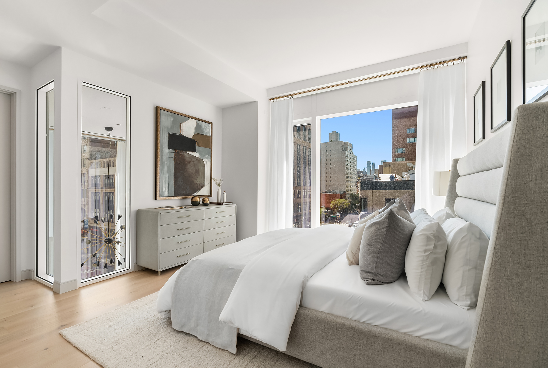 101 West 14th Street, Unit 4D Manhattan, NY 10011 - Photo 5 of 17 a bedroom with a large bed and a large mirror