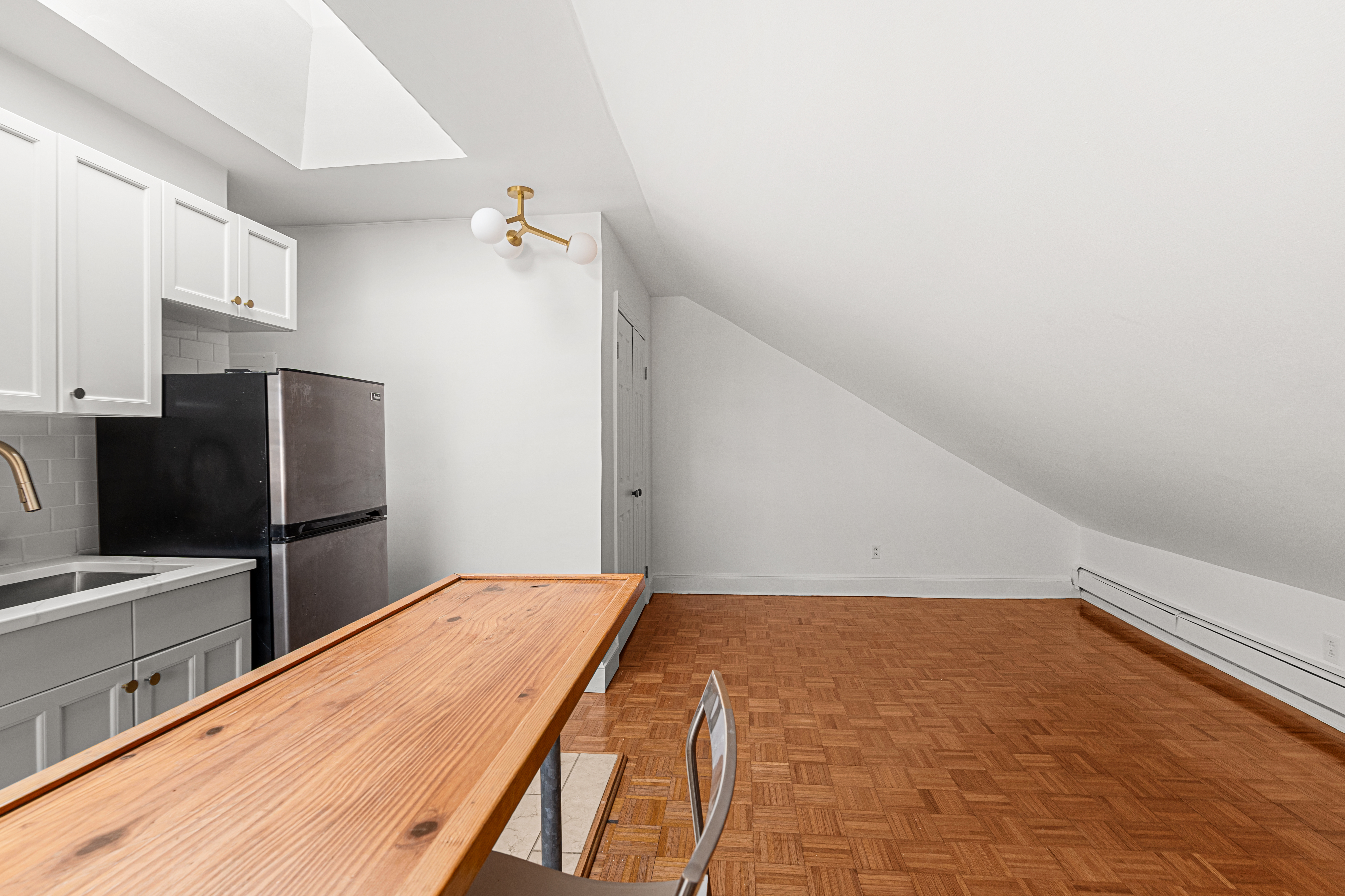 306 Lafayette Avenue, Unit 4 Brooklyn, NY 11238 - Photo 2 of 11 a bedroom with a bed and a refrigerator