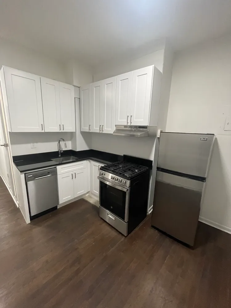 a kitchen with a cabinets and white appliances
