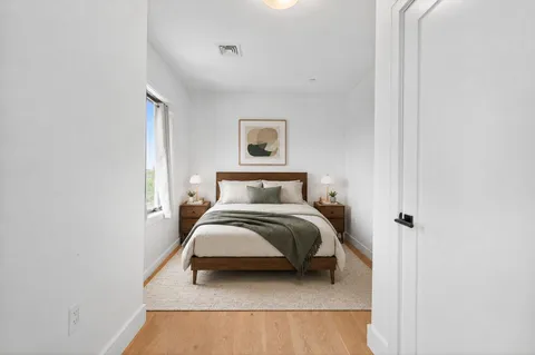 a bedroom with a bed and a wall painting