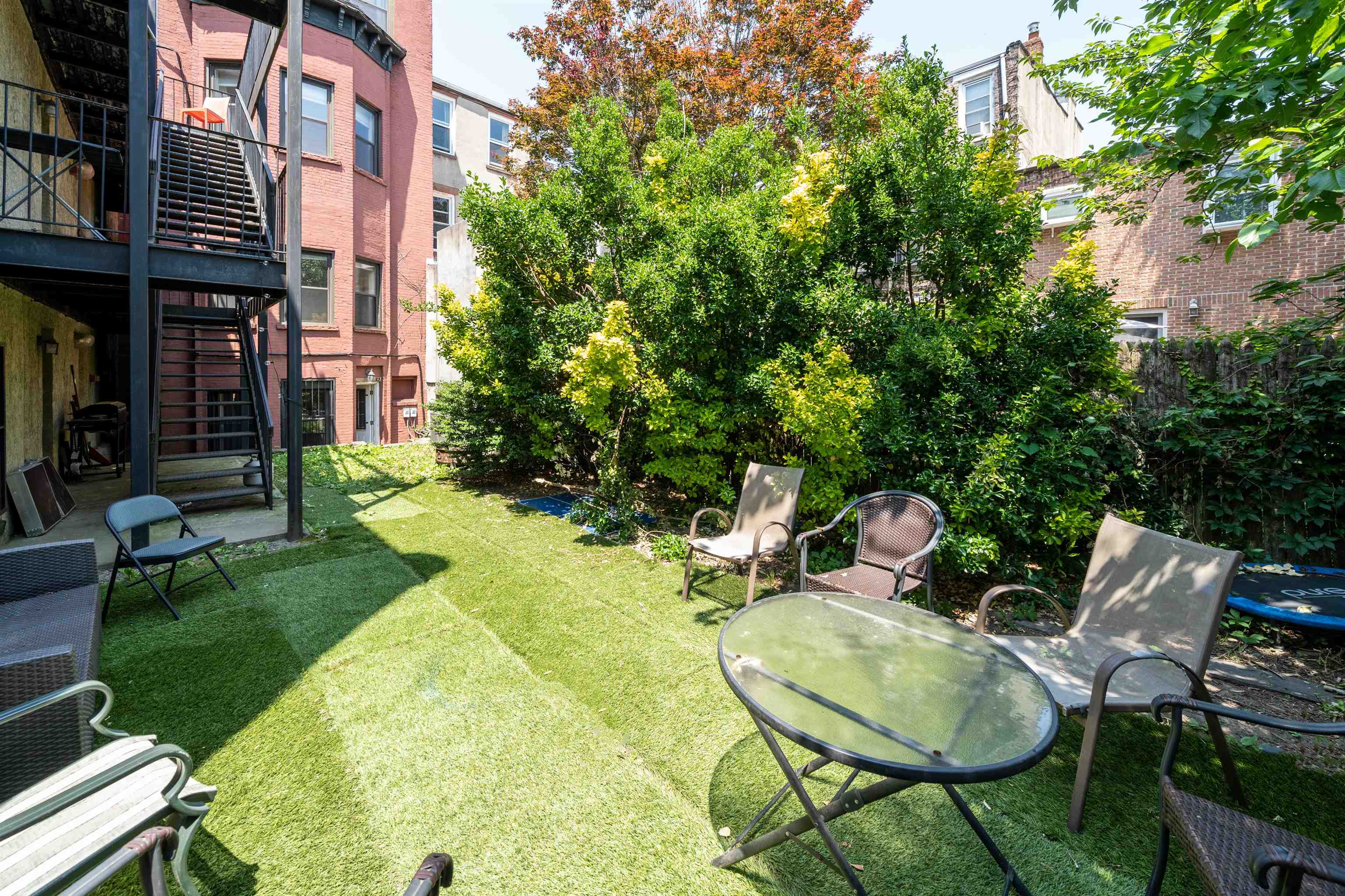 639 Garden Street, Unit 1 Hoboken, NJ 07030 - Photo 15 of 17 a backyard of a house with table and chairs