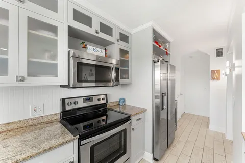 a kitchen with stainless steel appliances granite countertop a stove and a refrigerator