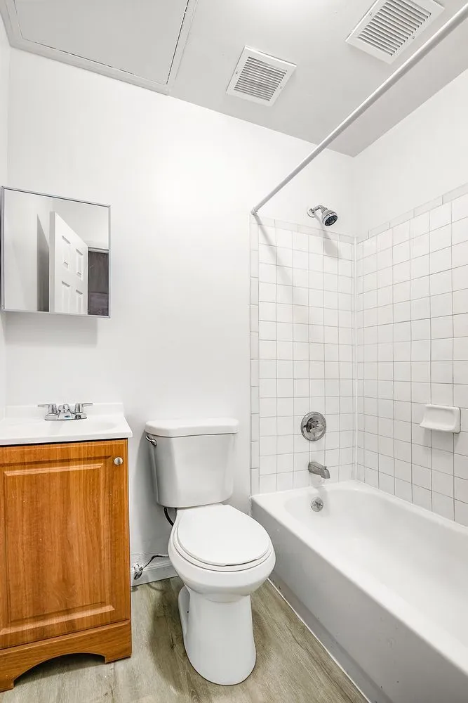 a bathroom with a toilet a sink and bathtub
