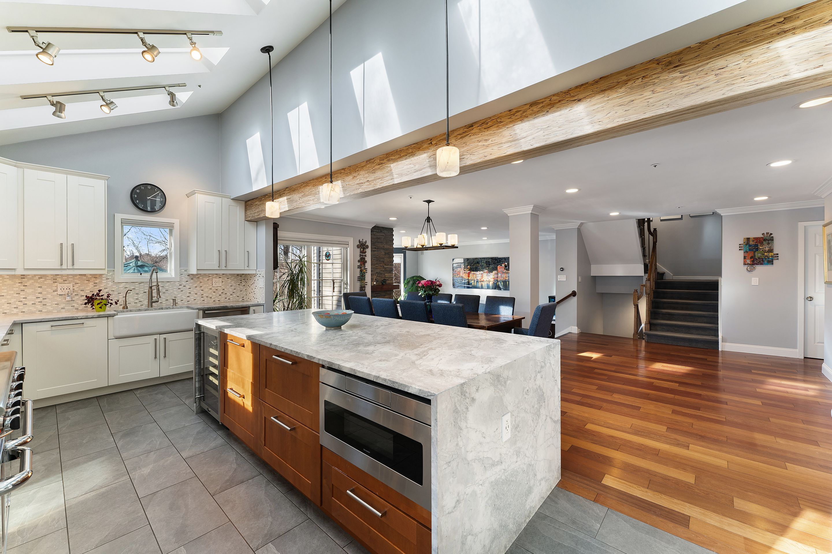 124 Boulder Ridge Road Scarsdale, NY 10583 - Photo 6 of 31 a large white kitchen with stainless steel appliances kitchen island granite countertop a large counter top and stove