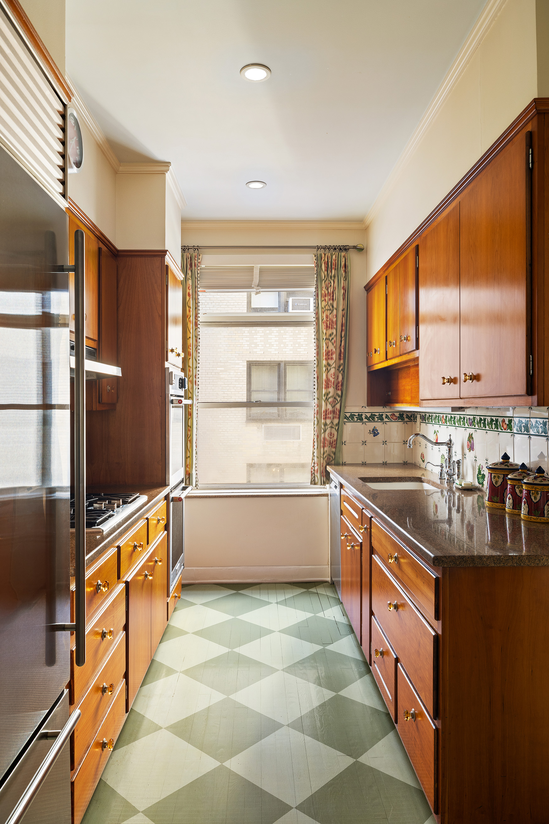 70 East 77th Street, Unit 6A Manhattan, NY 10075 - Photo 6 of 17 a large kitchen with stainless steel appliances a stove a sink and a refrigerator