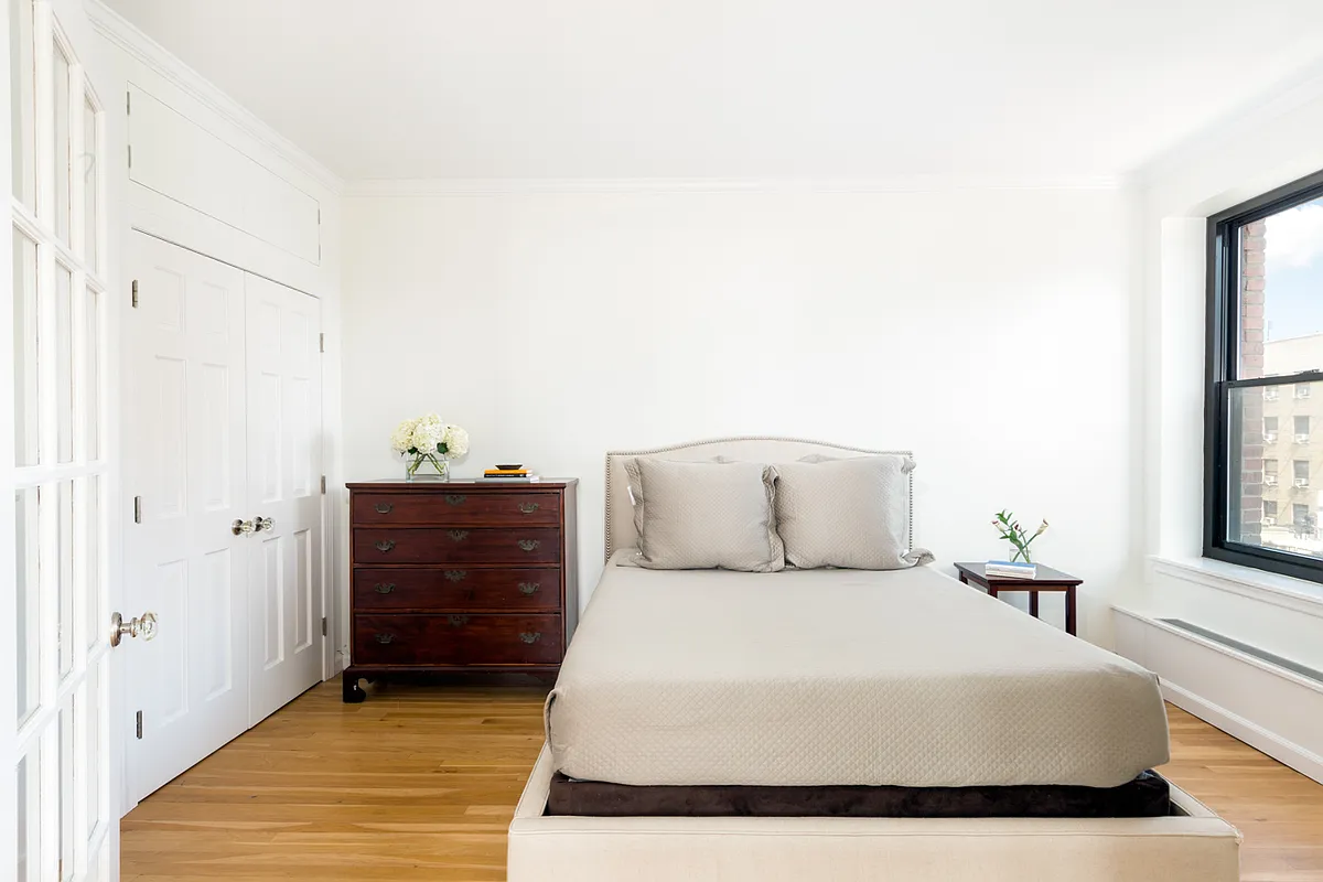 104 West 70th Street, Unit 7G Manhattan, NY 10023 - Photo 4 of 8 a bed room with a bed and a window