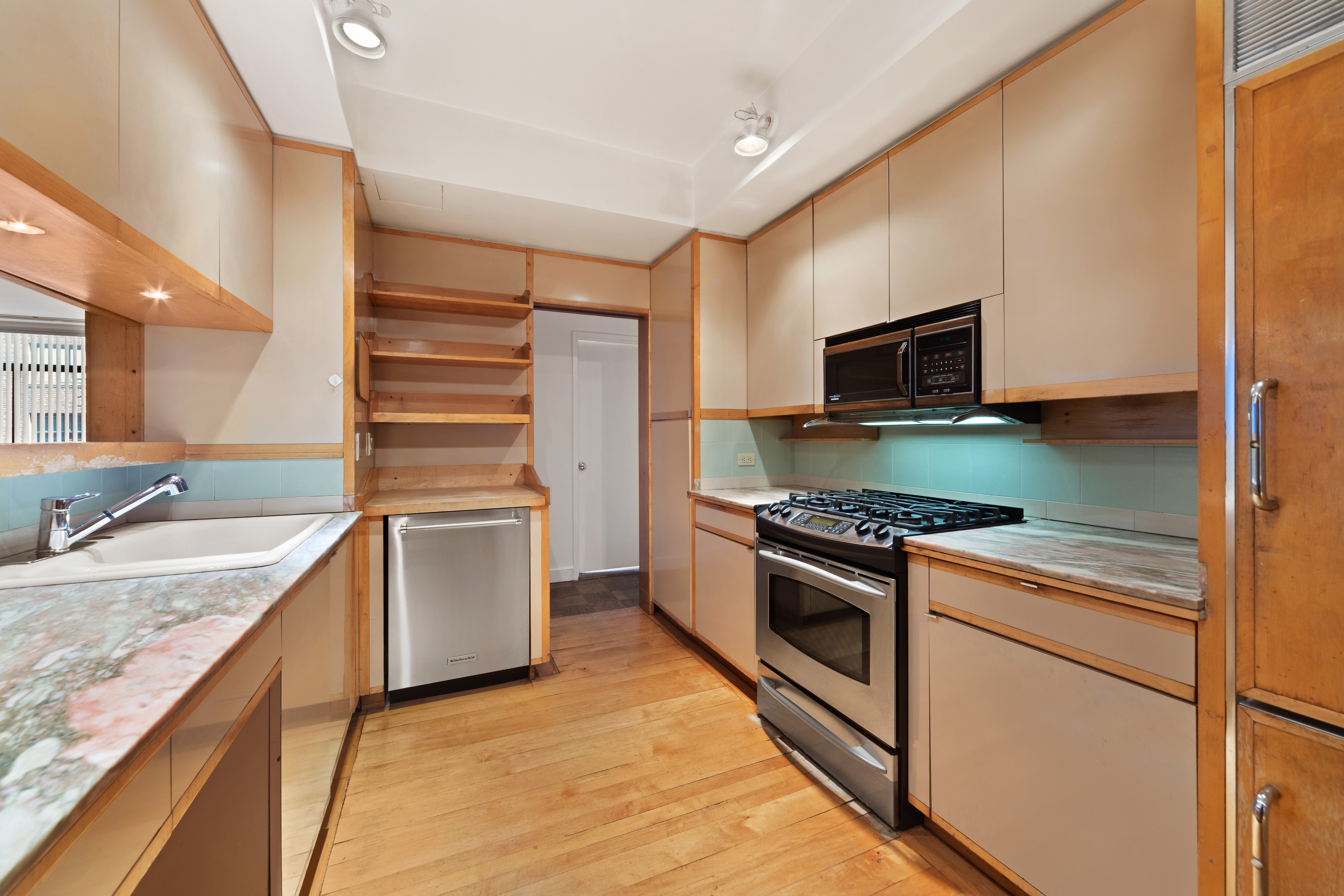 525 East 80th Street, Unit 11A Manhattan, NY 10075 - Photo 7 of 12 a kitchen with a sink stove and microwave
