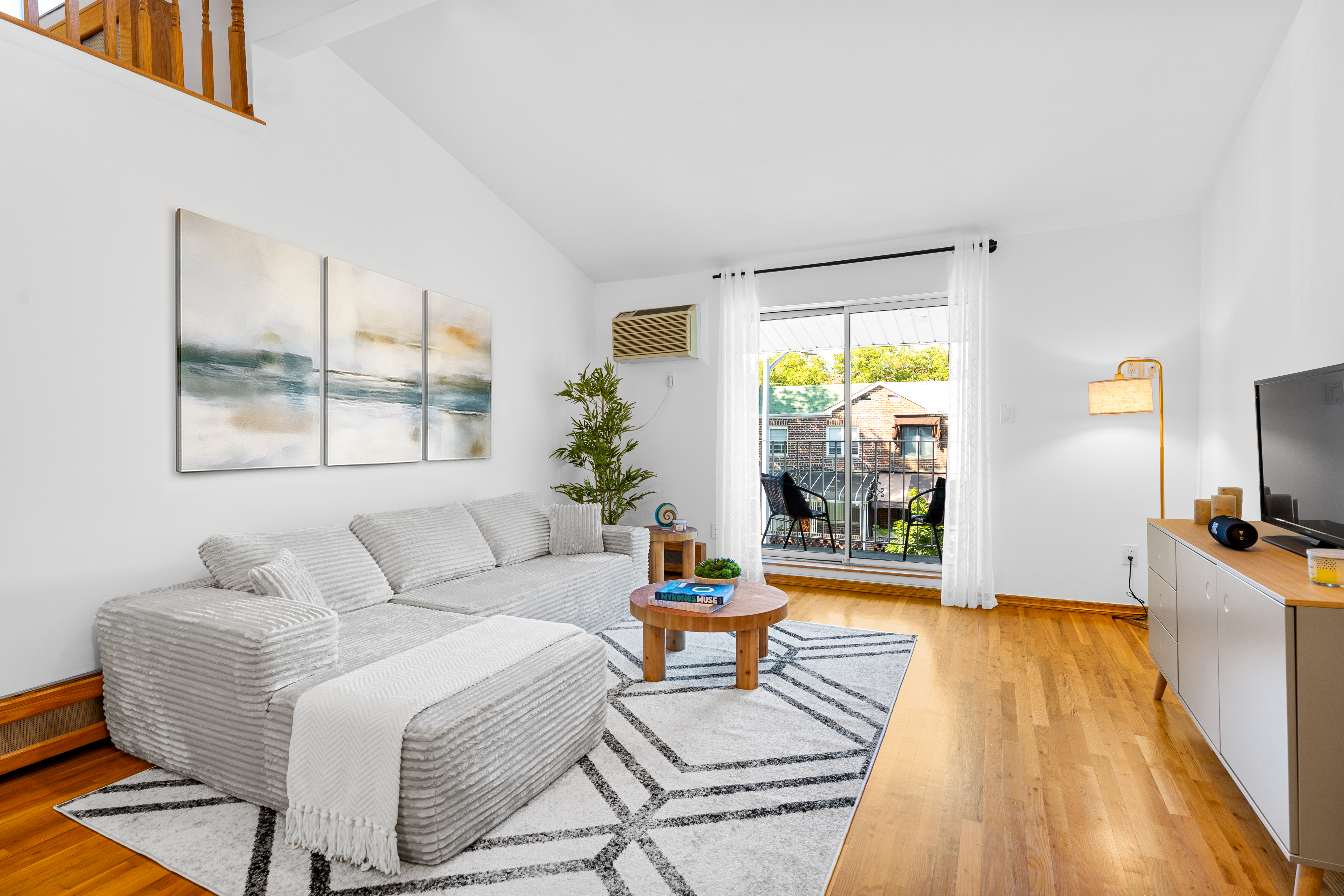 336 99th Street, Unit 15 Brooklyn, NY 11209 - Photo 2 of 7 a living room with furniture and a flat screen tv