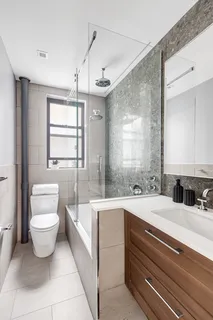 a bathroom with a sink toilet and granite