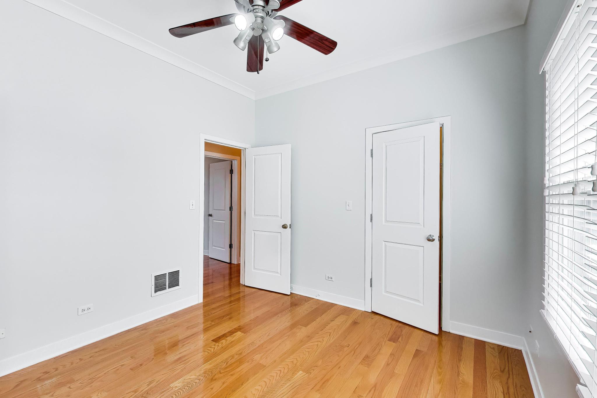 4845 North Springfield Avenue, Unit 2 Chicago, IL 60625 - Photo 15 of 32 an empty room with wooden floor closet and windows