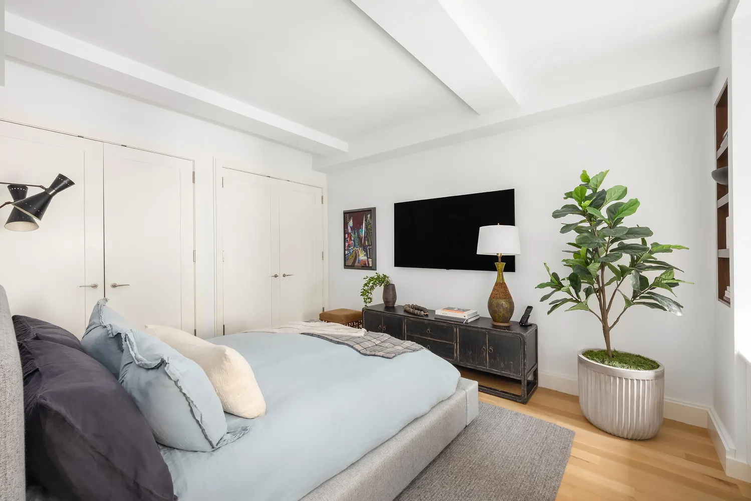 a bed room with a bed window and a television