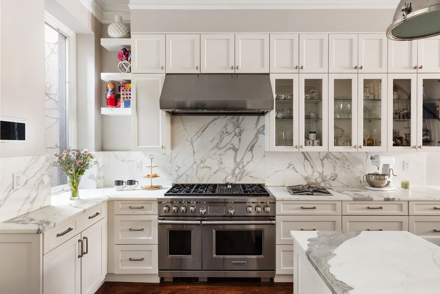 a kitchen with granite countertop a sink stove and cabinets