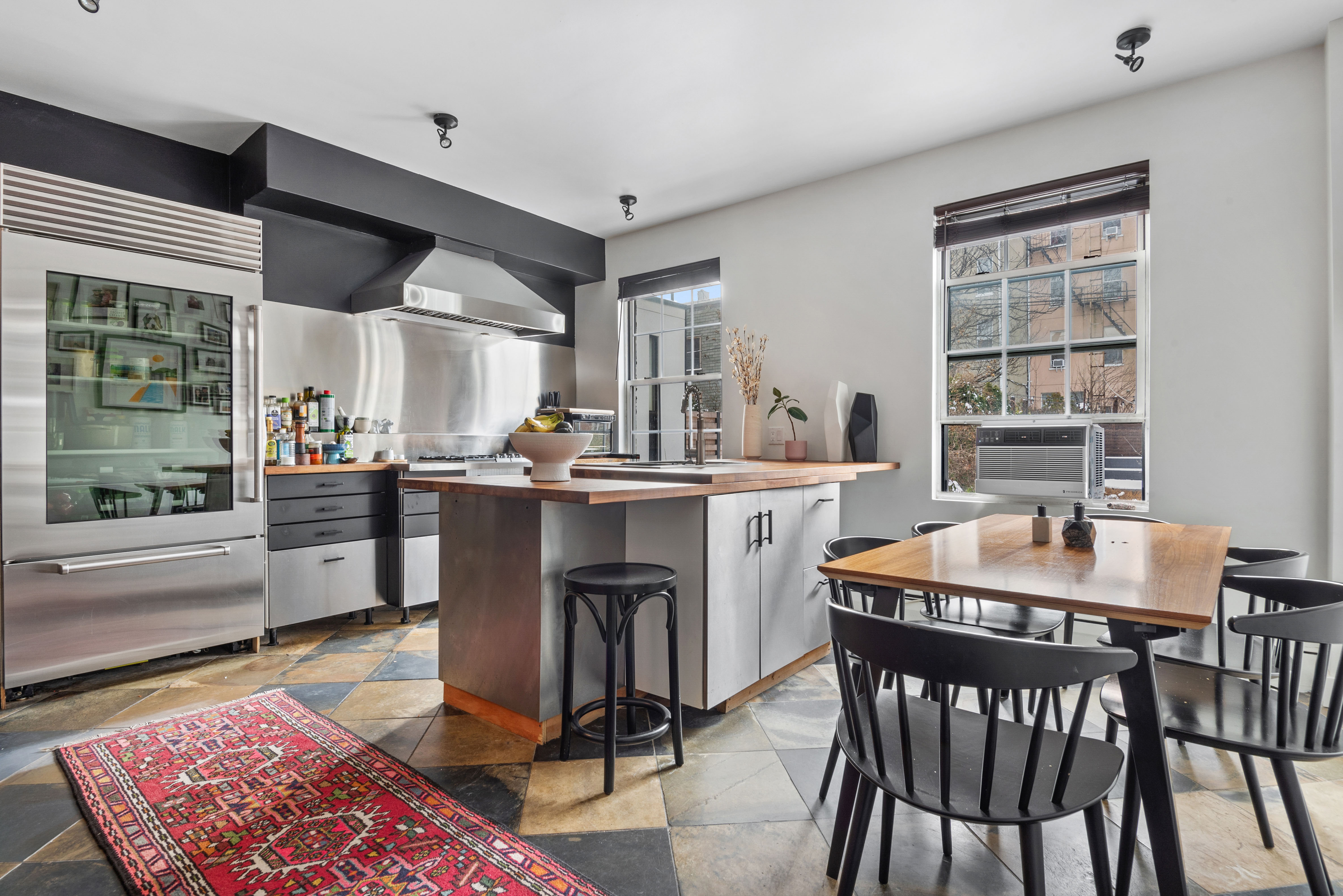 a dining room with a table chairs and a kitchen view