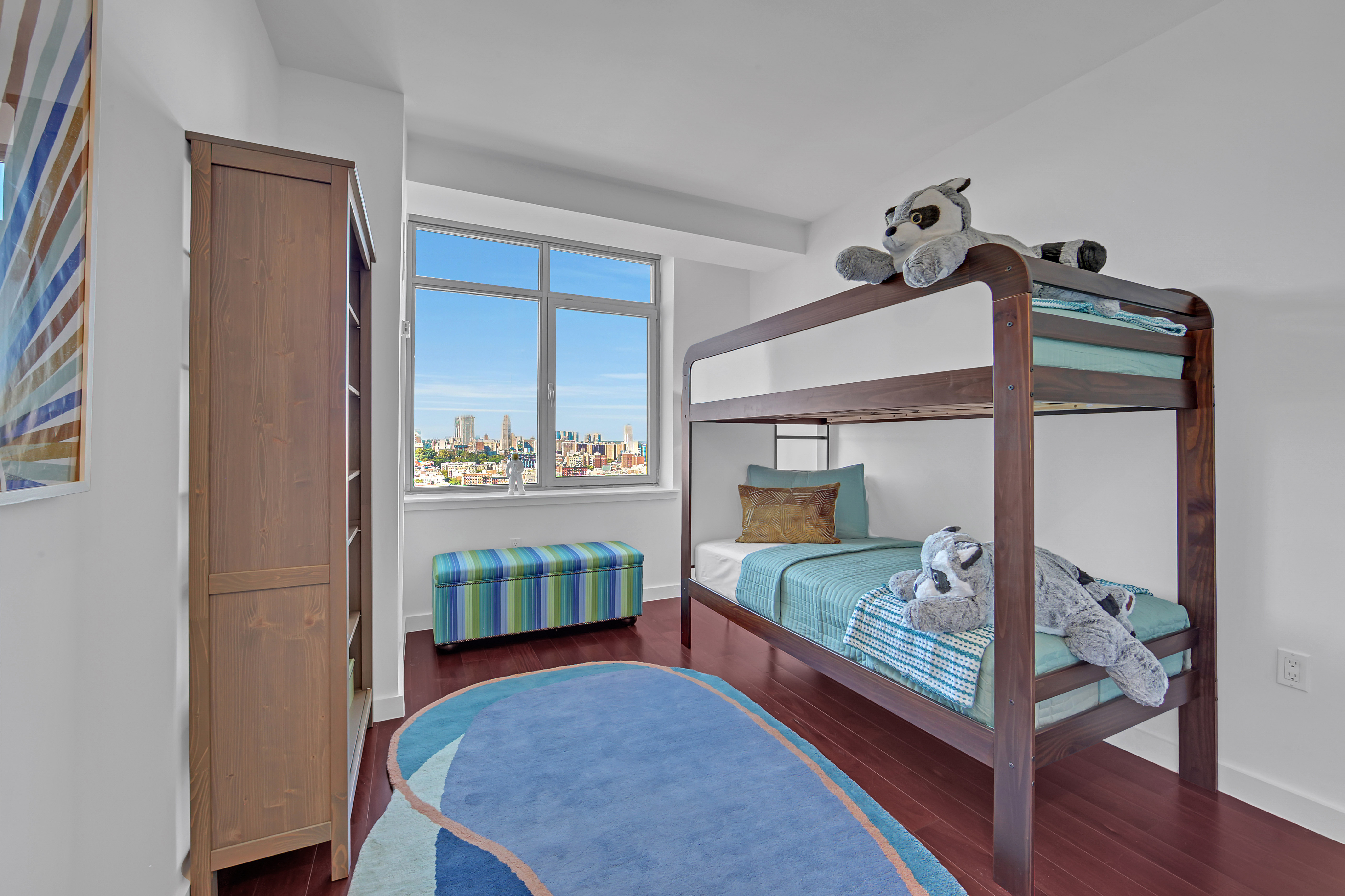 1485 5th Avenue, Unit 18/19H Manhattan, NY 10035 - Photo 15 of 24 a bedroom with a bed and a mirror