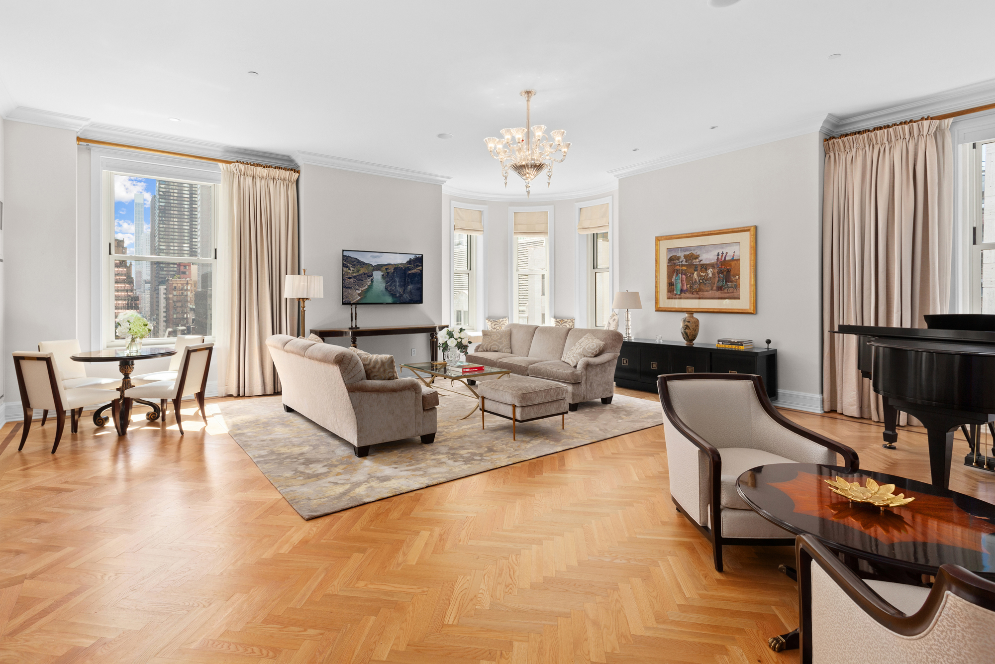 1 Central Park South, Unit 915 Manhattan, NY 10019 - Photo 6 of 29 a living room with furniture and a flat screen tv