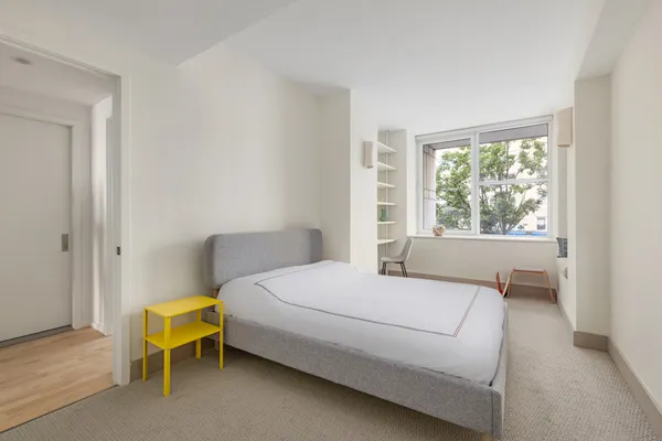 a bedroom with a bed and a window