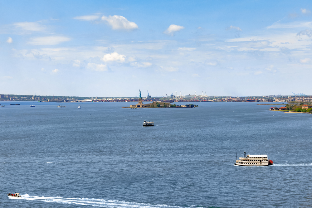30 West Street, Unit 19F Manhattan, NY 10004 - Photo 11 of 12 a view of a lake and mountain in the back