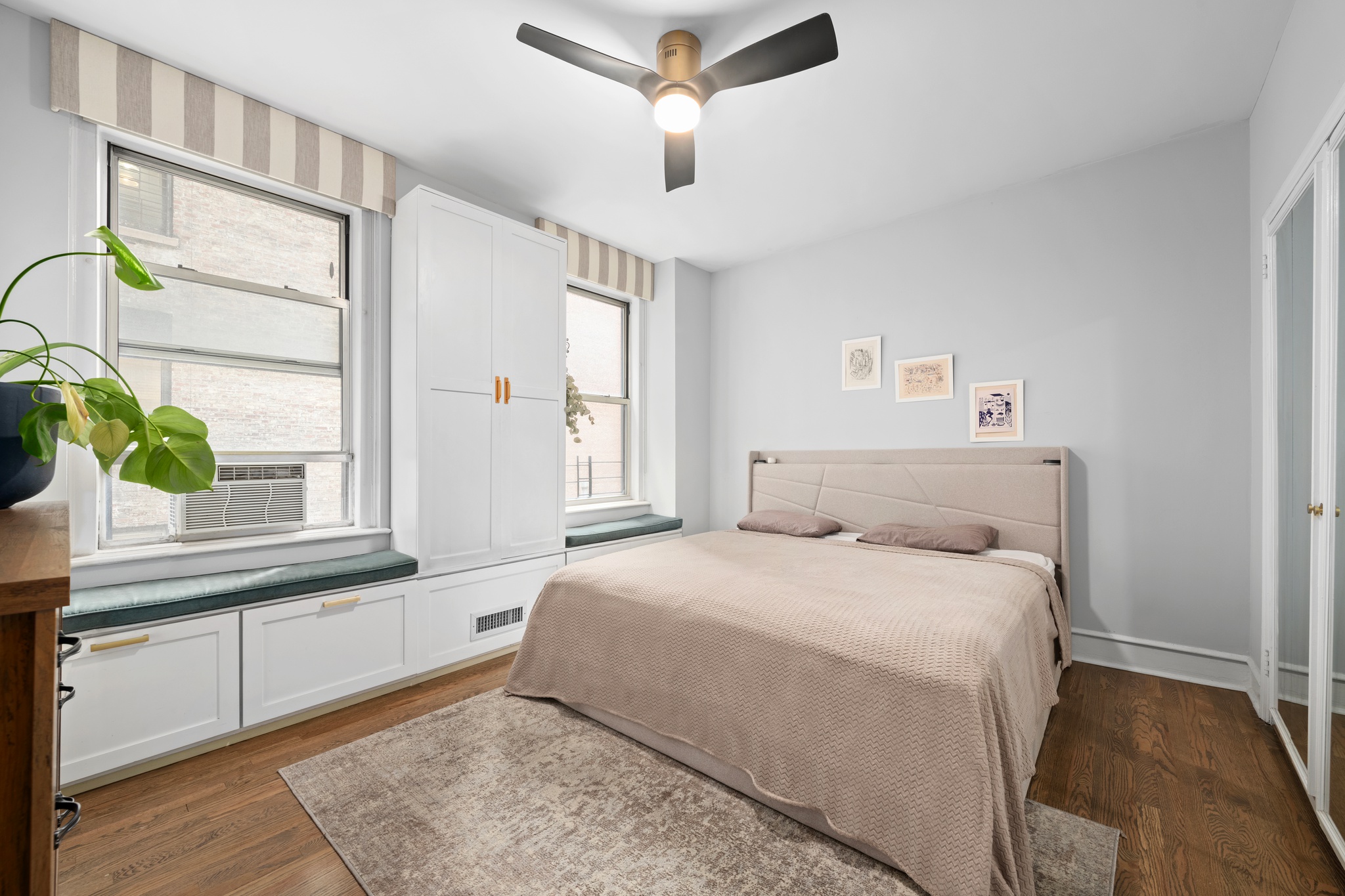 136 East 36th Street, Unit 3D Manhattan, NY 10016 - Photo 5 of 9 a bedroom with a bed a window and potted plant