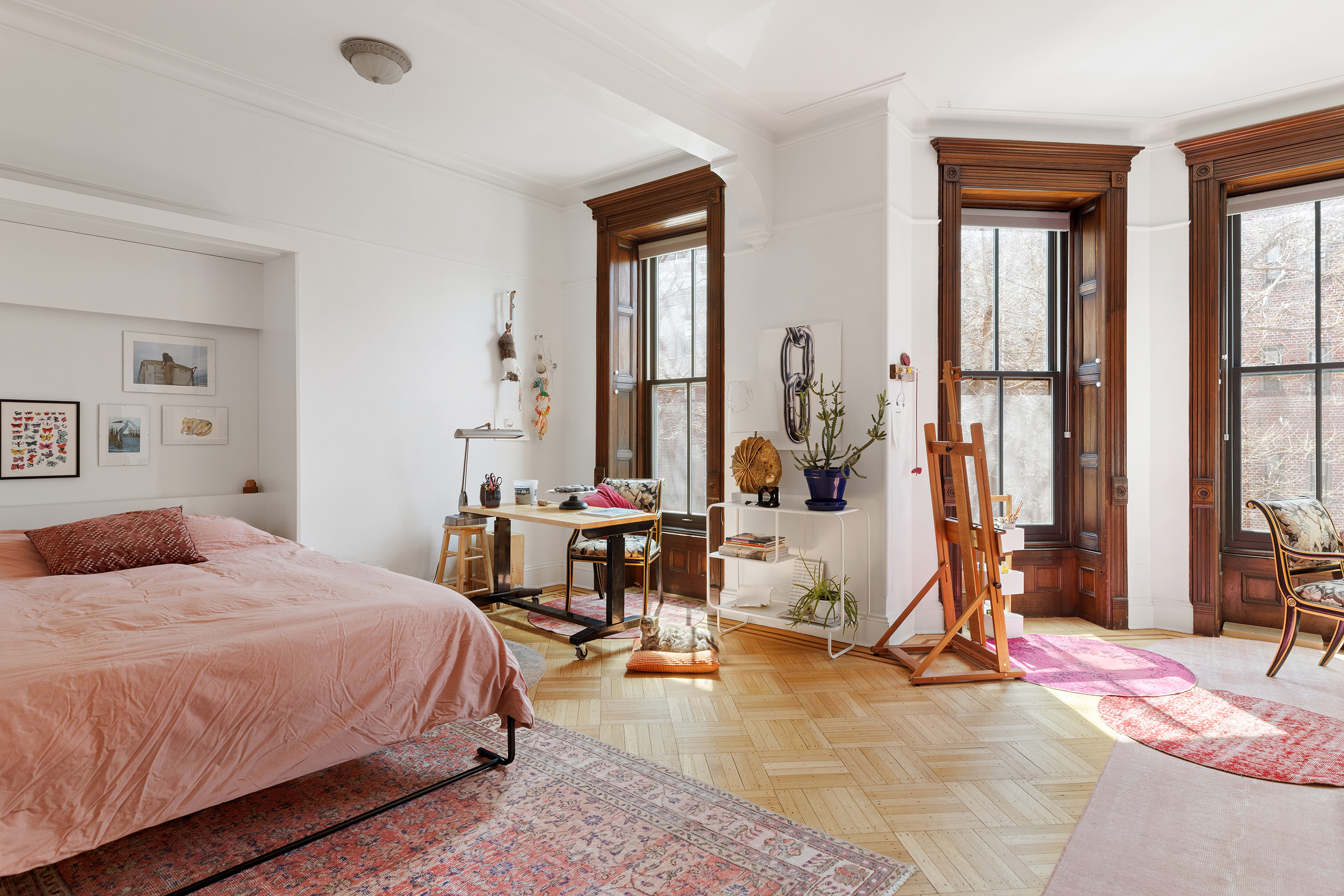 193 Sterling Place, Unit 2 Brooklyn, NY 11238 - Photo 9 of 15 a bedroom with a bed a table and large mirror next to a window