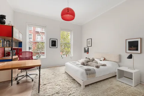 a bedroom with a bed and a chandelier