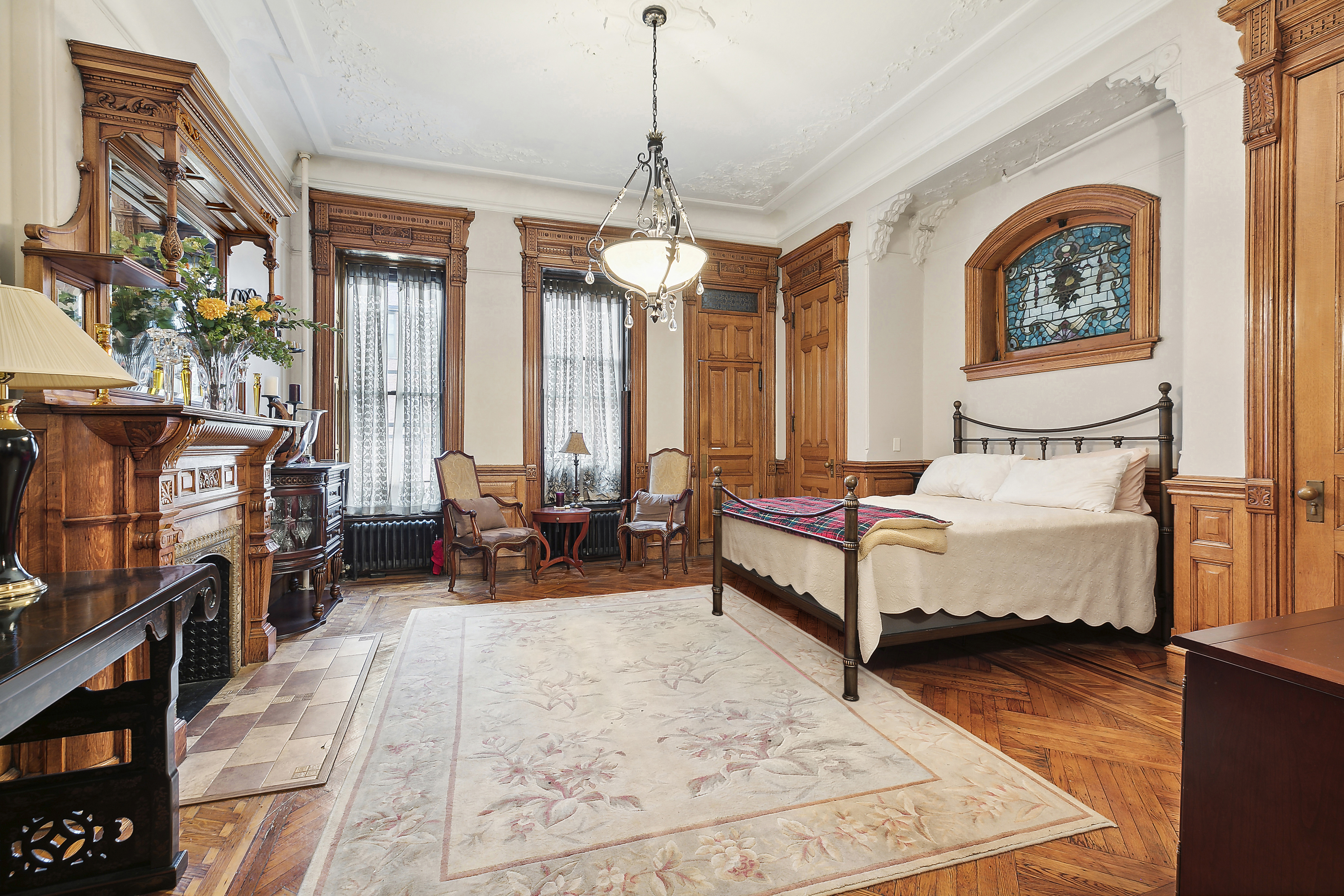 7 West 122nd Street Manhattan, NY 10027 - Photo 5 of 23 a bedroom with furniture and a large window