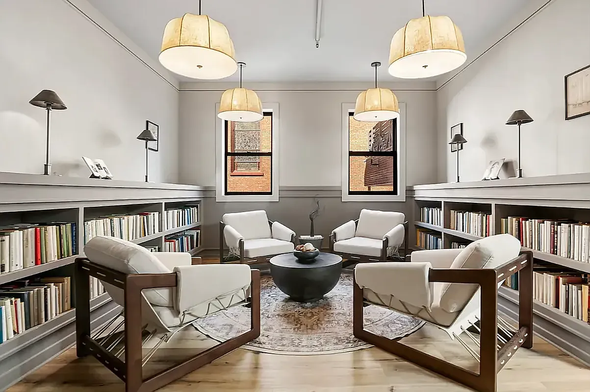 180 Bainbridge Street, Unit 211 Brooklyn, NY 11233 - Photo 20 of 21 a living room with furniture a bookshelf and a large window